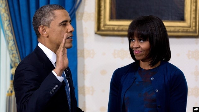 President Obama takes the oath of office at the official swearing-in ceremony in the Blue Room of the White House Jan. 20, 2013.