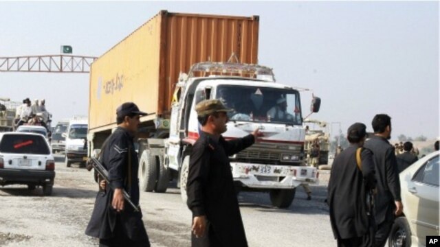 Pakistani security personnel stop truck carrying supplies for NATO forces in neighboring Afghanistan at Takhtabeg check post in Pakistani tribal area of Khyber, Pakistan, on their way to Torkham border post on Saturday, November  26, 2011.