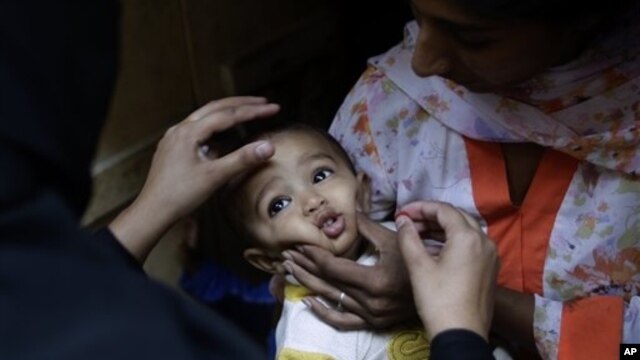 Child receives a polio vaccine in Islamabad, Pakistan, Oct. 16, 2012.