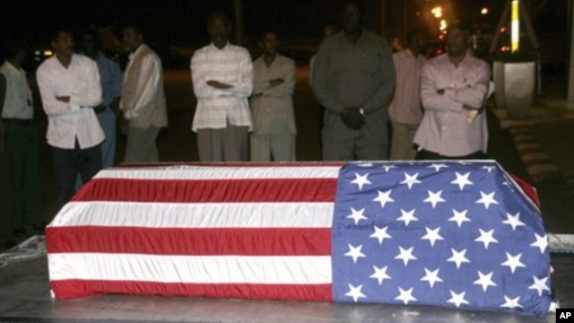 Sudanese men look at the flag-draped coffin of U.S. diplomat John Granville, who worked for the U.S. Agency for International Development. (file)