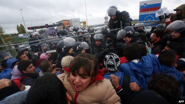 A child cries as migrants cross the Croatia-Slovenia border at Trnovec, Oct. 19, 2015.