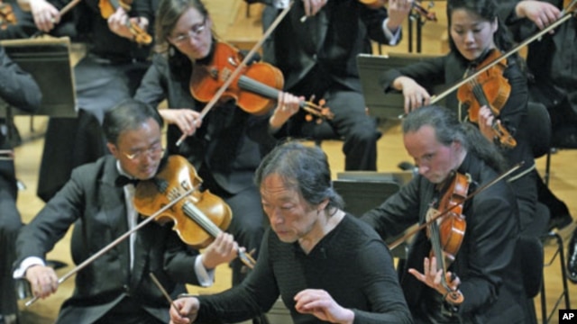South Korean maestro Chung Myung-whun, director of the Radio France Philharmonic Orchestra, conducts the last rehearsal with North Korea's Unhasu Orchestra and Radio France Orchestra in Paris, March 14, 2012.