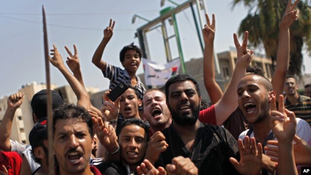 Libyans celebrate the liberation of their district of Qasr Bin Ghashir in Tripoli, Libya, August 27, 2011.