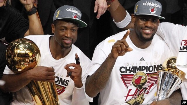 Dvejn Vejd sa trofejem Leri O'Brajen, namenjenom šampionu NBA lige, i Lebron Džejms sa priznanjem za najkorisnijeg igrača finalne serije koji nosi ime Bila Rasela   