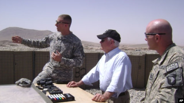 Secretary Gates receives a briefing from officers at Combat Outpost Senjaray, Afghanistan