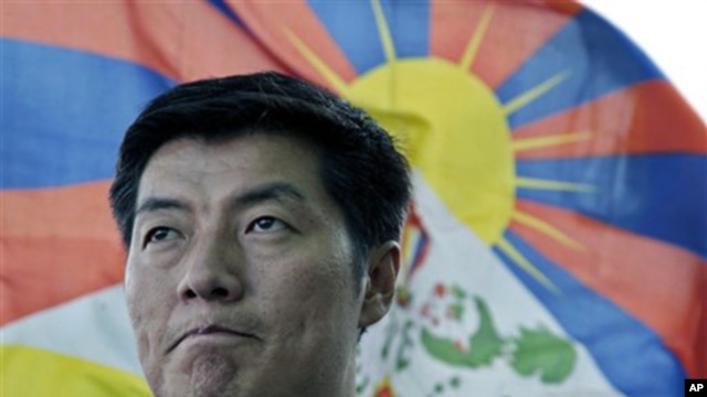 In this March 20, 2011 file photo, newly-elected Tibetan prime minister Lobsang Sangay talks to the Associated Press with a Tibetan flag in the background in Dharmsala, India.