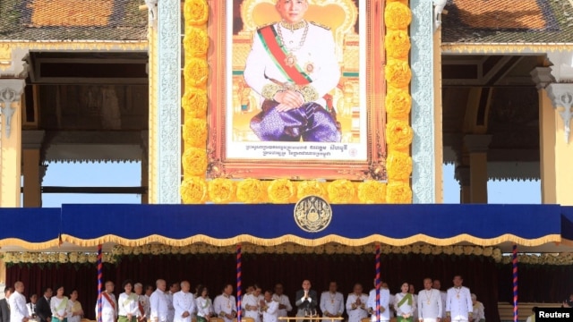 Cambodia's King Norodom Sihamoni (C) greets people from the Royal Palace during a ceremony to mark the 10th anniversary of his coronation, in Phnom Penh October 29, 2014.