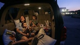 A family watches a movie at the Silver Moon Drive-In theater in Lakeland, Florida