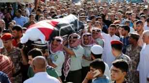 Jordanian soldiers and relatives of Belal Al-Zuhbe, one of the solders killed in an attack on a border military post near a camp for Syrian refugees, carry his body during his funeral at Nahleh village in the city of Jerash, north of Amman, Jordan, June 2
