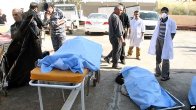 Bodies of bomb attack victims are seen outside a hospital in Tikrit, some 150 km (95 miles) north of Baghdad, 18 Jan 2011