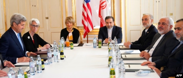 FILE - U.S. Secretary of State John Kerry, left, awaits the start of a meeting with Iranian Foreign Minister Mohammad Javad Zarif, second from right, after his return from Iran for international negotiations on nuclear policy in Vienna, Austria, June 30, 2015.
