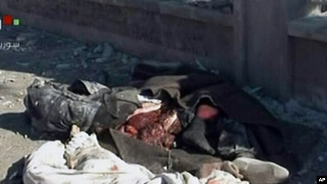 An image grab taken off the official Syrian TV shows the bodies of the victims covered with blankets at the scene of a blast in Syria's second largest city of Aleppo, February 10, 2012.