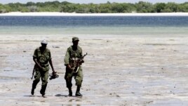 Somalia's Transitional Federal Government (TFG) soldiers patrol the Indian Ocean coastline in Burgabo, south of Kismayu in Somalia, December 14, 2011