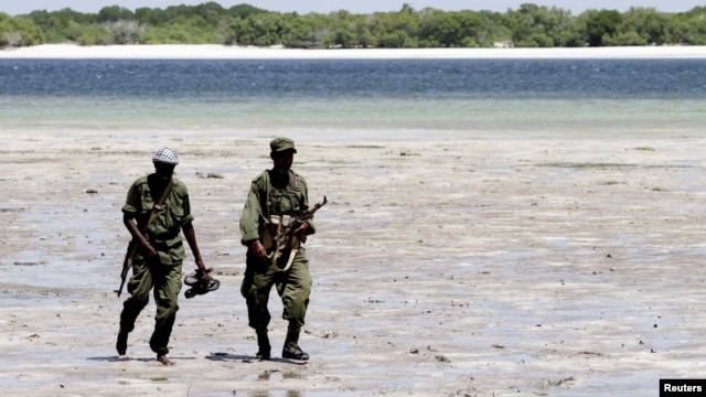Somalia's Transitional Federal Government (TFG) soldiers patrol the Indian Ocean coastline in Burgabo, south of Kismayu in Somalia, December 14, 2011