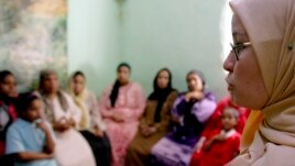 A counselor talks to a group of women to try to convince them that they should not have female genital mutilation performed on their daughters, in Minia, Egypt, Jun. 2006.