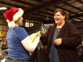 After submitting their holiday requests, families pick up presents and necessities from the Angel Tree warehouse. Tia McCoy asked for basic necessities for her son and daughter.