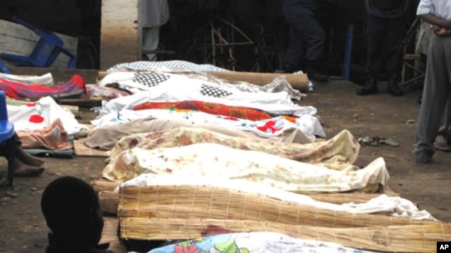 Bodies of victims of armed raiders covered-over with cloth are lined-up for identification on September 19, 2011 in the capital Bujumbura.