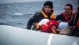 FILE - Migrants on a dinghy arrive from the Turkish coast at the Greek island of Lesbos, Jan. 29, 2016.