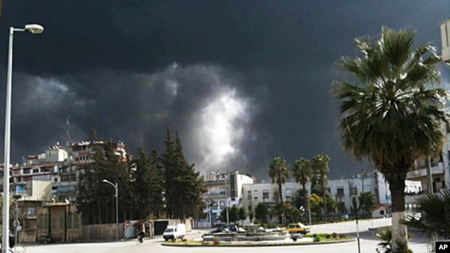 Black smoke rises from buildings in Homs, Syria, March 27, 2012 (AP is unable to independently verify the authenticity, content, location or date of this handout photo.)
