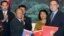 Wu Bangguo, chairman of the Standing Committee of the National People's Congress (NPC) of China, second right, and Heng Samrin, president of the Cambodian National Assembly shake hands after exchanging documents on cooperation between NPC and the Cambodia.