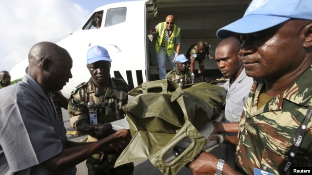 The bodies of the United Nations peacekeepers killed in western Ivory coast near the Liberia border arrive in Abidjan June 9, 2012. 