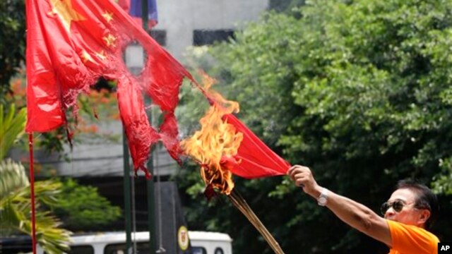 一名菲律宾退休警官在马尼拉焚烧中国国旗，抗议菲律宾人所说的中国侵犯领海行为。(资料照片)