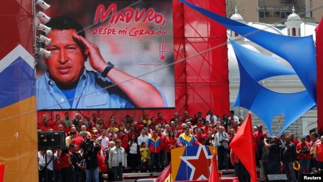 Venezuela's acting President Nicolas Maduro (center) talks to supporters after registering as a candidate for president in the April 14 election outside the national election board in Caracas on March 11, 2013. 