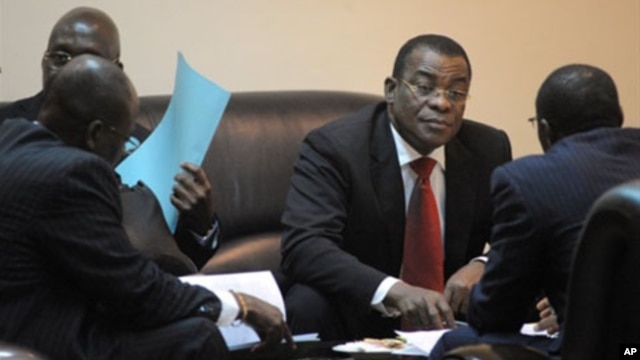 The representative of Ivorian incumbent President Laurent Gbagbo, Pascal N'guessan (C), speaks with members of his delegation on March 10, 2011 before the start of African Union talks in Addis Ababa