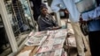 A Street vendor sells newpapers with elections headlines at a central street, Oct. 16, 2014 in Maputo. 