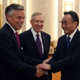 U.S. Senator Harry Reid (D-NV) looks on as U.S. ambassador to China Jon Huntsman (L) shakes hand with Wu Bangguo, chairman of the Standing Committee of the National People's Congress, at the Great Hall of the People in Beijing April 21, 2011