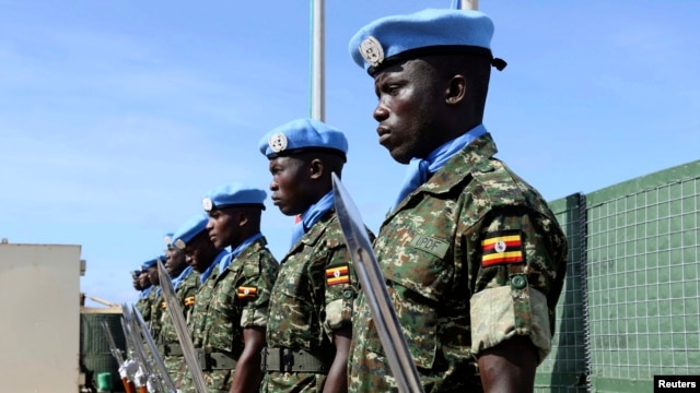 FILE - Ugandan peacekeeping troops stand during a ceremony at Mogadishu airport in Somalia.