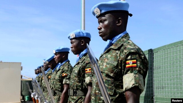 Ugandan peacekeeping troops stand during a ceremony at Mogadishu airport in Somalia May 18, 2014. U.N.-backed peacekeepers pushed the Islamist fighters out of Mogadishu in 2011, but the al Qaida-linked group has continued to launch guerrilla-style attacks.