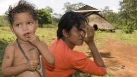 An ethnic minority Cambodian boy, left, stands next to his mother at a village in Mondul Kiri province some 265 kilometers (165 miles) northeast Phnom Penh, file photo. 