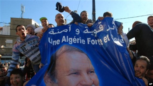 Pro-government protesters display a banner with the picture of Algerian President Abdelaziz Bouteflika in Algiers, March 5, 2011