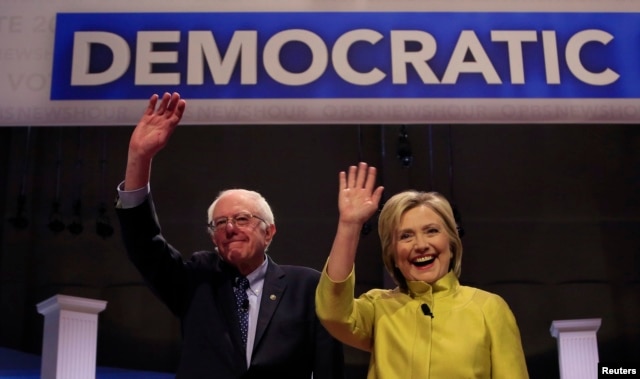 Democratic U.S. presidential candidates Senator Bernie Sanders and former Secretary of State Hillary Clinton arrive on stage ahead of the start of the PBS NewsHour Democratic presidential candidates debate in Milwaukee, Wisconsin, Feb. 11, 2016.