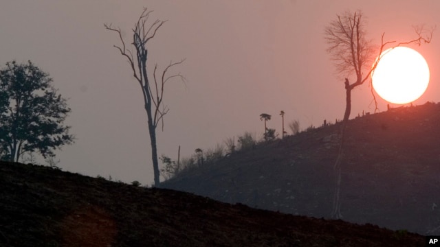 The sun sets near Pailin, Cambodia, in this Thursday March 10, 2005 photo, in an area hard hit by deforestation. (AP Photo/David Longstreath)
