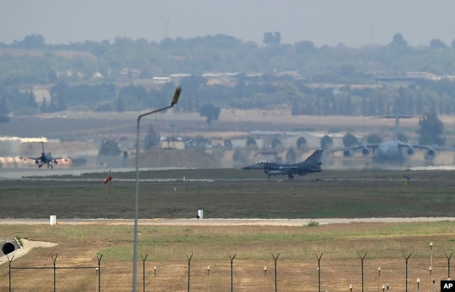 FILE - Turkish Air Force fighter planes maneuver on the runway at the Incirlik Air Base, in Adana, southern Turkey, Aug. 13, 2015.