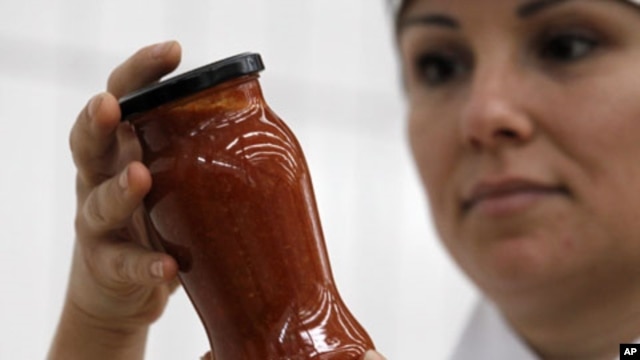 A worker inspects a jar of pasta sauce in one of Paolo Ricciulli's factories - which employs around 220 people at his Althea-Delfino group, Italy's biggest manufacturer of ready-made pasta sauce, with revenues of 62 million euros and two plants in Parma a