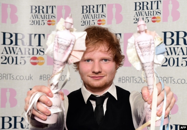 British singer-songwriter Ed Sheeran poses with his British album of the year award for 'X' and his British male solo artist award at the BRIT Awards 2015 in London, Feb. 25, 2015.
