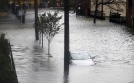 Floodwaters surround a car parked on a street in Hoboken, New Jersey, October 30, 2012, after Sandy, one of the biggest storms ever to hit the United States, roared ashore with fierce winds and heavy rain near Atlantic City.