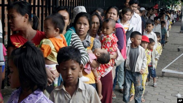 FILE - Cambodian villagers for countryside line up as wait for a medical check-up outside the children hospital of Kuntha Bopha, in Phnom Penh, Cambodia, July 11, 2012. 