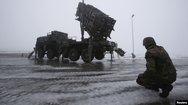German troops beside a Patriot missile battery during a media rehearsal, Warbelow, Dec. 18, 2012.