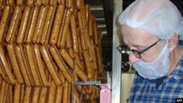 Turtle Island Foods founder Seth Tibbott examines freshly made Tofurky Italian sausages