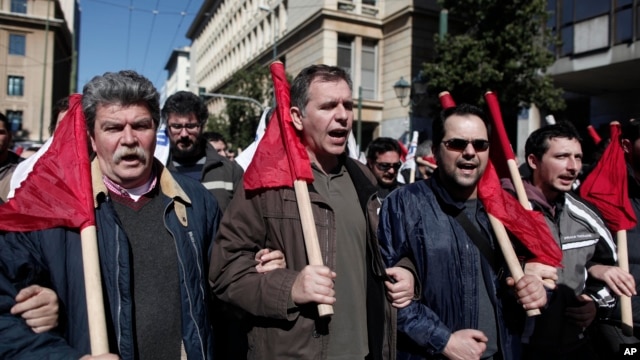 Members of pro-communist union PAME shout slogans during a protest in Athens,  February 20, 2013. 