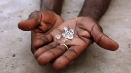 An illegal diamond dealer from Zimbabwe displays diamonds for sale in Manica, near the border with Zimbabwe, September 19, 2010.