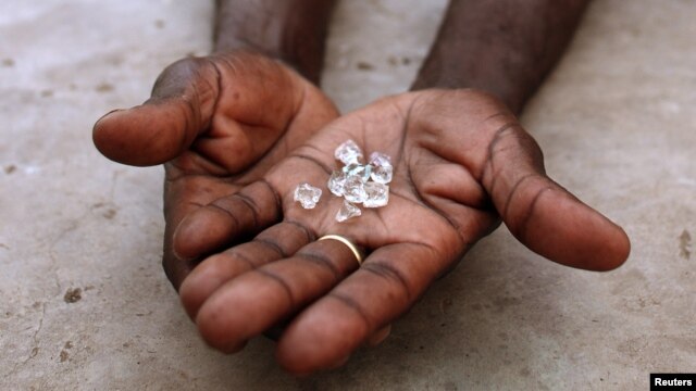 An illegal diamond dealer from Zimbabwe displays diamonds for sale in Manica, near the border with Zimbabwe, September 19, 2010.
