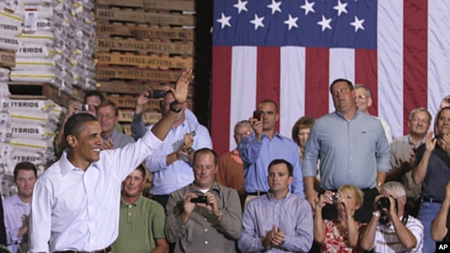 President Barack Obama arrives at a town hall meeting at Wyffels Hybrids Inc., in Atkinson, Illinois, during his three-day economic bus tour, August 17, 2011