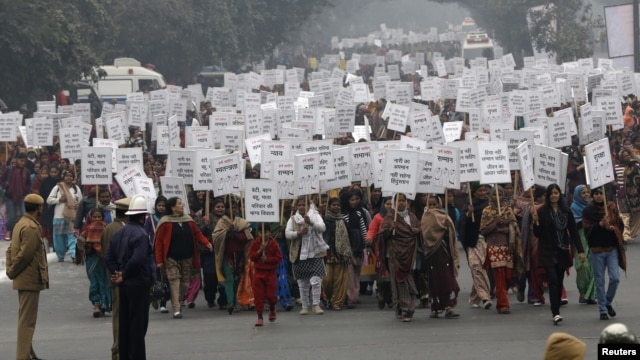 Women hold placards as they march during a rally organized by Delhi Chief Minister Sheila Dikshit (unseen) protesting for justice and security for women, in New Delhi, January 2, 2013.