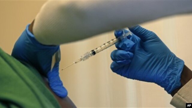 Registered nurse Charlene Luxcin administers a flu shot to a patient at the Whittier Street Health Center in Boston, Massachusetts, January 9, 2013. Boston declared a public health emergency Wednesday. 