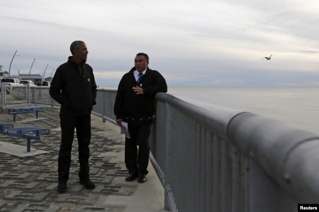 U.S. President Barack Obama (L) tours the Kotzebue Shore Avenue Project, an effort to protect against rising sea levels in Kotzebue, Alaska Sept. 2, 2015.